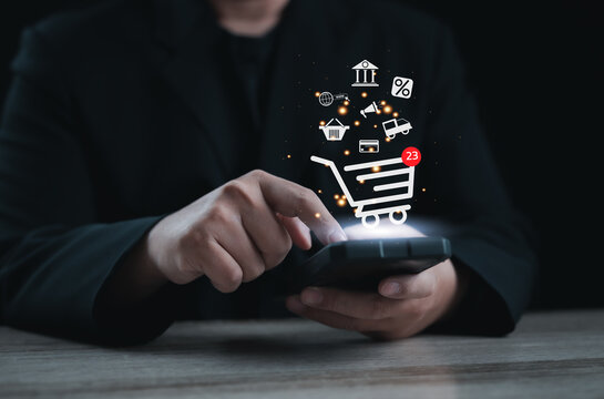 Mobile shopping and online payment concept. Businessperson using smartphone with digital shopping cart and e-commerce icons, representing online retail, delivery, and secure transaction technology.