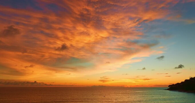 aerial view of exotic sweet sky in sunset at Karon beach Phuket.
Scene of colorful romantic sky sunset with changing the brilliant yellow sky gradually turned red. 
4k video travel concept.
