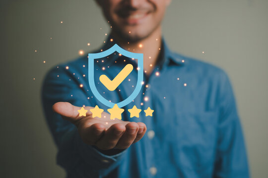 Man presents a shield with a checkmark and five stars symbolizing quality assurance customer satisfaction and toprated service highlighting trust and reliability in business