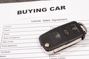 Car key, inscription buying car and form of vehicle sales agreement. Sales or purchases new or used vehicle