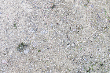 A pathway surface texture with small stones, gravel and grit closeup background
