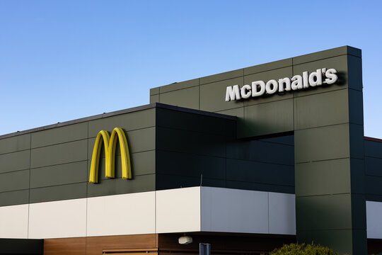 Wroclaw, Poland- October 25, 2025: Modern exterior facade of McDonalds restaurant building with recognizable yellow logo and clean architectural design. Global fast food brand and urban lifestyle