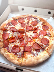 Vertical photo of Pepperoni pizza in a box