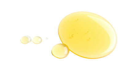 Droplets of golden liquid on a stark black background, showcasing texture and shape