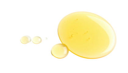 Droplets of golden liquid on a stark black background, showcasing texture and shape