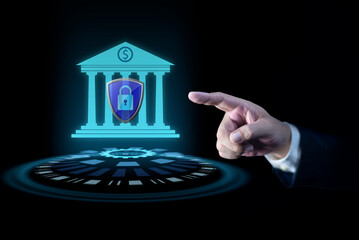 Businessman hand pointing at creative glowing blue bank building hologram with protective shield on dark background. Business, finance and online banking concept