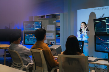 young Asian software development manager leads a late-night office discussion with his executive team, mentoring developers and analyzing source code to guide programming and project development