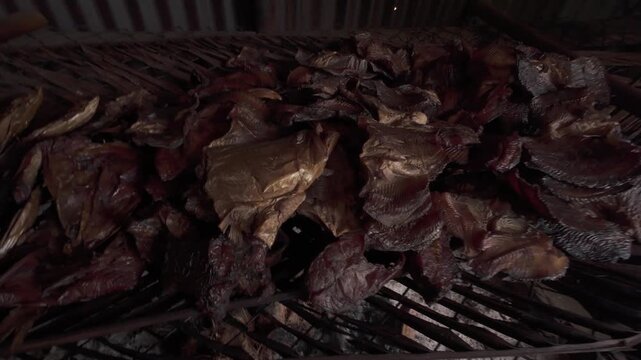 4K 60 FPS video of the process of making smoked fish, a food with traditional and environmentally friendly preservation practices in Merauke, Papua.