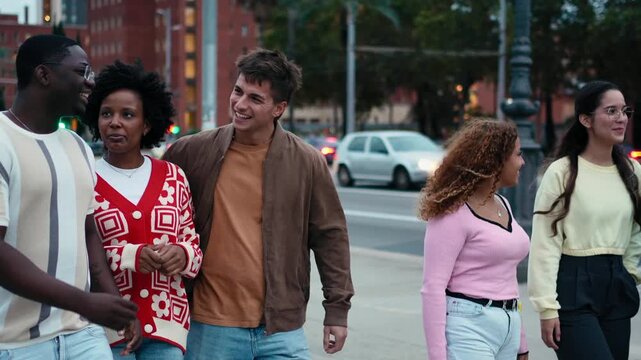 Group of young friends enjoying good moments and having fun together, walking bonding outdoors in the city at sunset
