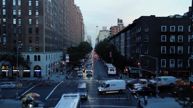 Dynamic timelapse of a busy New York City intersection during sunset, with heavy traffic and warm city lights, filmed in 2013.
