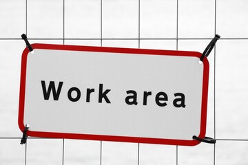 Work area sign on a fence