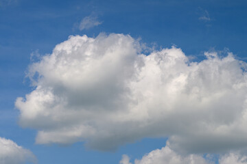 Fluffy Clouds Floating Gracefully Against a Bright Blue and Beautiful Sky Above Us All