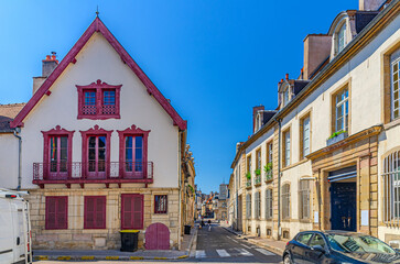 Street in Dijon city historical centre with old typical houses medieval buildings, Dijon old town in sunny summer day, Bourgogne-Franche-Comte region, France