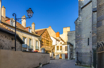 Small yard with old medieval house in old town Dijon city historical centre in sunny summer day, Bourgogne-Franche-Comte region, France