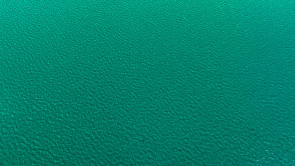 Full-frame aerial view of the emerald green sea surface. Ideal for backgrounds, textures and patterns.