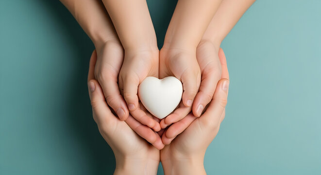 Family holding a white heart in their hands on a blue background, love and care concept
