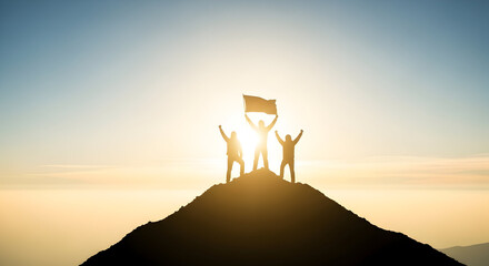 Silhouette of three people celebrating on a mountain top with a flag at sunset or sunrise