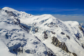 The Mont Blanc mountain range in the French Alps The picture was taken on a clear, sunny day the mountain is covered in white snow and Blue sky View from the aiguille du midi mountain