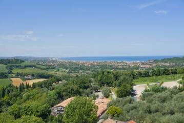 Elevated panoramic view from Gradara over the Italian hills toward the coastline and Adriatic Sea.
