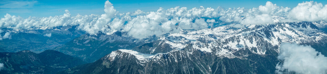 A view of a ridge of jagged, high, snow-covered mountains in the French Alps Photo taken from the Aiguille du Midi mountain Chamonix large snow cover with footprints is visible