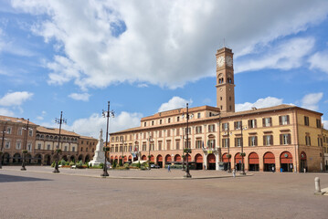 Monumental Piazza Saffi in Forlì, Italy, featuring a clock tower and porticoed Renaissance architecture.