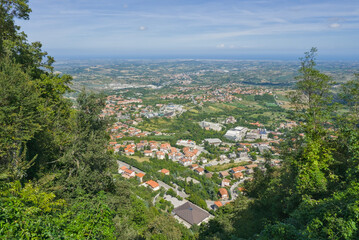 High-angle view from Monte Titano showing the San Marino townscape and the expansive, rolling landscape