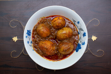 Savor the comforting aroma of a freshly prepared appam crowned with a perfectly cooked egg, promising a delightful start to your day.