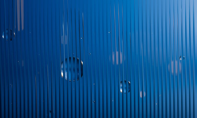 Water drops on blue ribbed surface, abstract liquid background.