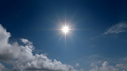 Radiant sun with bright rays illuminates a clear blue sky scattered with white clouds