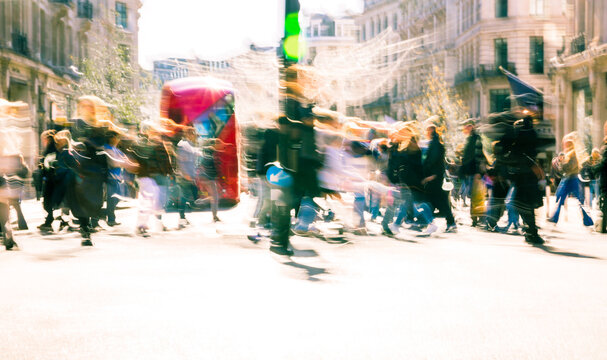Beautiful postmodernism motion of people walking in London street at sunny day. Shoppers and tourists crossing Oxford circus - Powered by Adobe