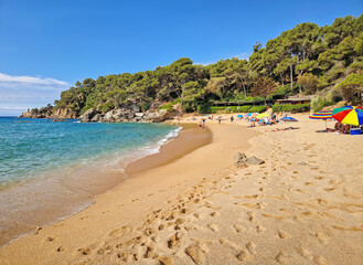 Playa Santa Cristina located in Lloret de Mar on the Costa Brava, Spain. Beautiful beach with fine golden sand and crystal-clear water, sheltered by pine covered cliffs