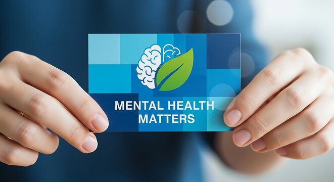 Human Hands Holding Mental Health Matters Card with Brain and Leaf Icon in Modern Office Setting