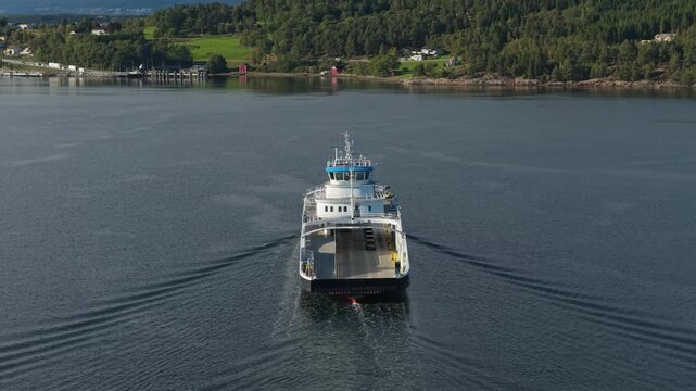 Aerial scene of vehicle ferry in narrow Norwegian fjord waters