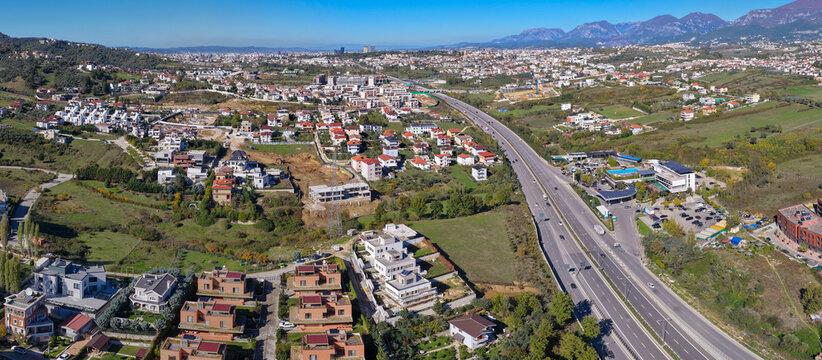 Aerial panorama of Tirana&rsquo;s eastern suburbs showing the Tirana&ndash;Elbasan highway and developing Sauk&ndash;Fark&euml; residential areas.