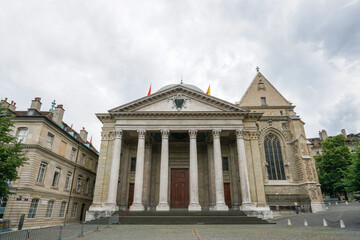 A large building in Geneva Switzerland with a clock tower and a large dome