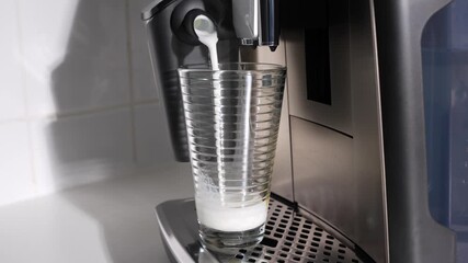 Espresso cascades into a foamy milk glass, creating soft marbled patterns. Cafe vibes at home.