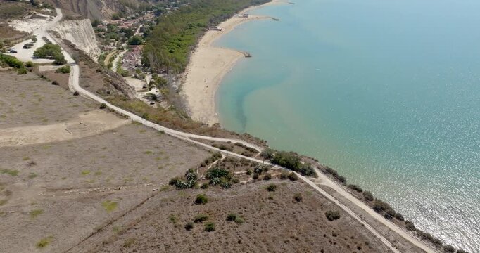 Aerial view of the beach of Eraclea Minoa, located in the province of Agrigento, Sicily, Italy. It's a long sandy beach overlooking the Mediterranean Sea. The sea's colors range from blue to turquoise