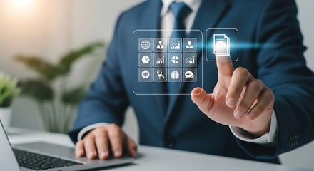 Businessman touching a futuristic interface with icons representing data analytics, business growth, and digital technology on a desk with a laptop