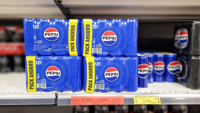 Almeria, Spain - November 07, 2025: Pepsi beverage packs displayed prominently on supermarket shelf, showcasing vibrant blue packaging and promotional pricing for consumers seeking refreshing drinks