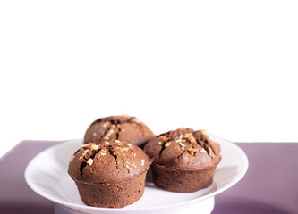 delicious chocolate cupcakes on white plate on pink background