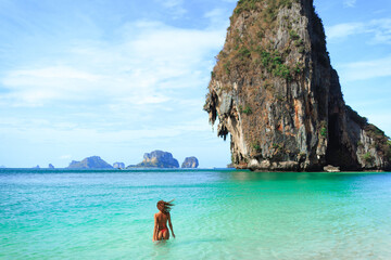 Woman Swimming in Turquoise Sea at Phra Nang Beach in Krabi Thailand