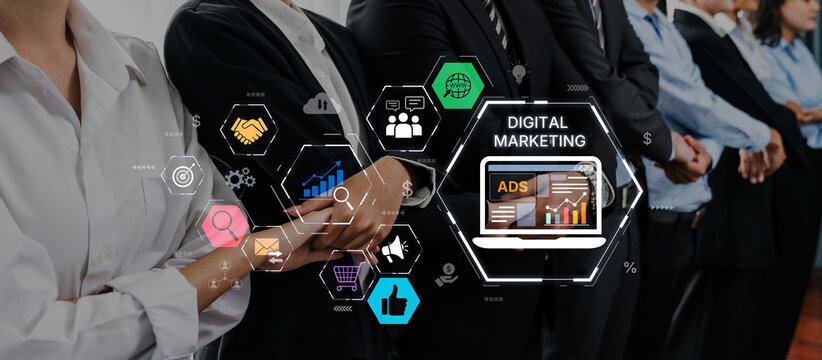 A group of professionals stands in a modern office, collaboratively discussing digital marketing strategies, highlighted by visual elements showcasing ads and growth metrics. Trope