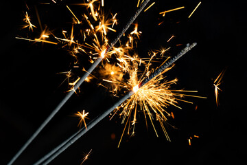 Bright Sparklers Burning on Pure Black Background