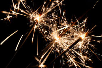 Fototapeta premium Bright Sparklers Burning on Pure Black Background