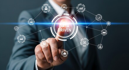 Businessman touching a futuristic interface with the words data driven in the center, symbolizing data analysis and decision making