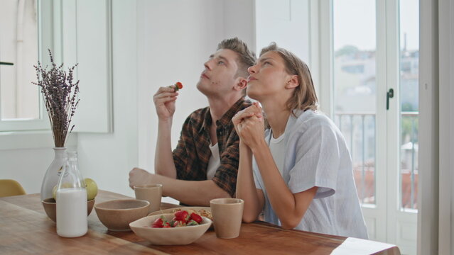 Young family having conversation in kitchen closeup. Lovely couple eat breakfast - Powered by Adobe