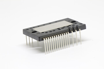 Rear three-quarter view highlighting the dense array of connector leads on an IPM (Intelligent Power Module) with central metal heat-spreader