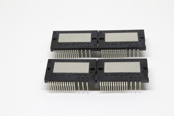 Four identical IPM (Intelligent Power Module) packages arranged in a neat grid on a white background, showing dense connector pin banks for power and control