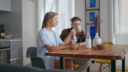 Joyful family enjoying breakfast together. Loving couple talk in sunny morning