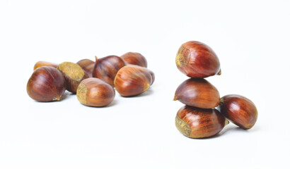 Chestnuts stacked on a white background.